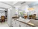 Open kitchen overlooking living area with bright light and white cabinetry at 3038 E Marlette Ave, Phoenix, AZ 85016