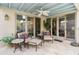 Outdoor patio featuring travertine flooring, ceiling fan, and two seating areas with comfortable furniture at 3038 E Marlette Ave, Phoenix, AZ 85016