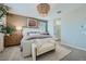 Stylish main bedroom features a decorative light fixture, neutral walls, and a view to the bathroom at 3315 S Lotus St, Mesa, AZ 85212