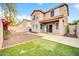 Backyard featuring artificial grass and a covered patio at 34916 N 31St Ave, Phoenix, AZ 85086