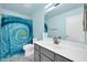 Bathroom featuring a modern vanity and sink, a custom shower curtain, and blue walls at 34916 N 31St Ave, Phoenix, AZ 85086