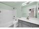 Bathroom with a tub, grey vanity, white countertops, and a large mirror at 34916 N 31St Ave, Phoenix, AZ 85086