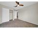 Bedroom featuring neutral walls, carpet, ceiling fan, and a closet with white doors at 34916 N 31St Ave, Phoenix, AZ 85086