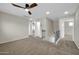 Carpeted hallway with a ceiling fan and stairway that leads to other rooms at 34916 N 31St Ave, Phoenix, AZ 85086