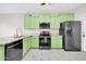 Modern kitchen featuring green cabinets, stainless steel appliances, and granite countertops at 34916 N 31St Ave, Phoenix, AZ 85086