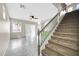 Bright staircase with carpeted steps and gray railing leading to the upper level of the home at 34916 N 31St Ave, Phoenix, AZ 85086