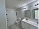 Newly renovated bathroom with dual sinks, and a bathtub with tiled enclosure at 4002 N 58Th Dr, Phoenix, AZ 85031