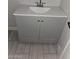 Bathroom vanity with white top, gray cabinets, and updated fixtures at 4002 N 58Th Dr, Phoenix, AZ 85031