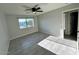 Cozy bedroom with a ceiling fan, new tile flooring, and bright natural light at 4002 N 58Th Dr, Phoenix, AZ 85031