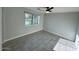 Bright bedroom with a ceiling fan, natural light, and tile flooring at 4002 N 58Th Dr, Phoenix, AZ 85031