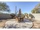 Circular backyard patio area with an outdoor dining set and desert landscaping at 4033 E Wildcat Dr, Cave Creek, AZ 85331