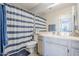 Bathroom featuring a vanity with a white countertop, a mirror, and a shower with a blue striped curtain at 4033 E Wildcat Dr, Cave Creek, AZ 85331