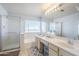 Bright bathroom featuring double sinks, a tub, and a separate glass-enclosed shower at 4033 E Wildcat Dr, Cave Creek, AZ 85331