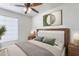 Bright bedroom featuring a bed with wood frame, stylish lamps, and contemporary artwork at 4033 E Wildcat Dr, Cave Creek, AZ 85331