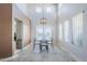 Dining area with a geometric pendant light and large windows, providing ample natural light at 4033 E Wildcat Dr, Cave Creek, AZ 85331