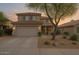 Charming two-story home featuring a tile roof, neutral colors, a two-car garage, and desert landscaping at 4033 E Wildcat Dr, Cave Creek, AZ 85331
