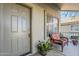 Inviting front porch with a cozy chair, potted flowers, and a view of the neighborhood at 4033 E Wildcat Dr, Cave Creek, AZ 85331