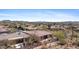 Wide aerial view of a desert community with lush landscaping and mountain views at 41802 N Bridlewood Way, Anthem, AZ 85086