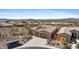 Aerial view of a desert home with a three-car garage, desert landscaping, and mountain views at 41802 N Bridlewood Way, Anthem, AZ 85086