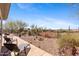 Inviting backyard patio with lounge chairs, desert landscaping, and privacy fence at 41802 N Bridlewood Way, Anthem, AZ 85086