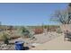 Backyard with a concrete patio, desert landscaping, and a wrought-iron fence at 41802 N Bridlewood Way, Anthem, AZ 85086