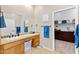 Bright bathroom with sink, vanity, mirror, and walk-in closet view at 41802 N Bridlewood Way, Anthem, AZ 85086