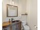 Charming half-bathroom featuring rustic vanity, vessel sink, and decorative mirror at 41802 N Bridlewood Way, Anthem, AZ 85086