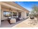 Relaxing covered patio featuring ceiling fans, comfortable seating, and an outdoor dining area at 41802 N Bridlewood Way, Anthem, AZ 85086