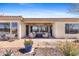 Charming covered patio with ceiling fans, cozy seating, and lovely desert garden accents at 41802 N Bridlewood Way, Anthem, AZ 85086