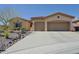 Charming single-story home boasting a three-car garage and a well-maintained desert landscaped front yard at 41802 N Bridlewood Way, Anthem, AZ 85086