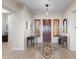 Elegant foyer featuring a decorative tile inlay, wooden door, and matching side tables at 41802 N Bridlewood Way, Anthem, AZ 85086