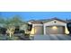 Inviting single-story home featuring desert landscaping, a neutral color scheme and a two-car garage at 41802 N Bridlewood Way, Anthem, AZ 85086