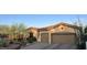 Charming single-story home with a two-car garage, desert landscaping, and a tile roof at 41802 N Bridlewood Way, Anthem, AZ 85086