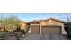Attractive single-story home with a two-car garage, desert landscaping, and a tile roof at 41802 N Bridlewood Way, Anthem, AZ 85086