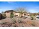 Charming desert home with desert landscaping, mature trees, rock features, and a private two-car garage at 41802 N Bridlewood Way, Anthem, AZ 85086