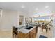 The kitchen's central island with sink opens to the living and dining areas at 41802 N Bridlewood Way, Anthem, AZ 85086