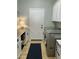 Bright laundry room with modern washer and dryer, plenty of counter space and storage cabinets at 41802 N Bridlewood Way, Anthem, AZ 85086
