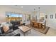 Open-concept living room with dining area featuring large windows and desert views at 41802 N Bridlewood Way, Anthem, AZ 85086