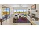 Bright living room with fireplace, large windows showcasing desert landscape, and tiled floors at 41802 N Bridlewood Way, Anthem, AZ 85086