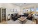 Cozy living room features two leather sofas, a stone-topped coffee table, and natural light at 41802 N Bridlewood Way, Anthem, AZ 85086