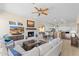 Open concept living space featuring a fireplace, TV, and a seamless flow into the kitchen at 41802 N Bridlewood Way, Anthem, AZ 85086