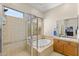 Relaxing bathroom with a soaking tub, tiled shower, and natural light from window at 41802 N Bridlewood Way, Anthem, AZ 85086