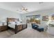 Spacious main bedroom with a large window, ceiling fan, and rustic wood furniture at 41802 N Bridlewood Way, Anthem, AZ 85086