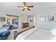 Bedroom features a wood bed frame, a ceiling fan, and sliding glass doors to the patio at 41802 N Bridlewood Way, Anthem, AZ 85086