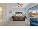 Bedroom boasting a wood bed frame, ceiling fan, and a bright window view at 41802 N Bridlewood Way, Anthem, AZ 85086