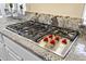 Close-up of Wolf stovetop with granite countertops, perfect for creating culinary masterpieces at 41802 N Bridlewood Way, Anthem, AZ 85086