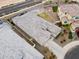 An aerial view of a well-maintained single-Gathering home showcasing the tiled roof, driveway, and landscaped backyard at 5428 N 188Th Ln, Litchfield Park, AZ 85340