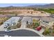 Aerial view showcasing a modern home with desert landscaping, a circular driveway, and close proximity to nearby amenities at 5428 N 188Th Ln, Litchfield Park, AZ 85340