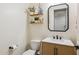 Bathroom featuring a modern vanity, toilet, and decorative shelving at 5428 N 188Th Ln, Litchfield Park, AZ 85340