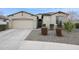 Charming single-story home with neutral stucco, a well-manicured front yard, and a convenient two-car garage at 5428 N 188Th Ln, Litchfield Park, AZ 85340